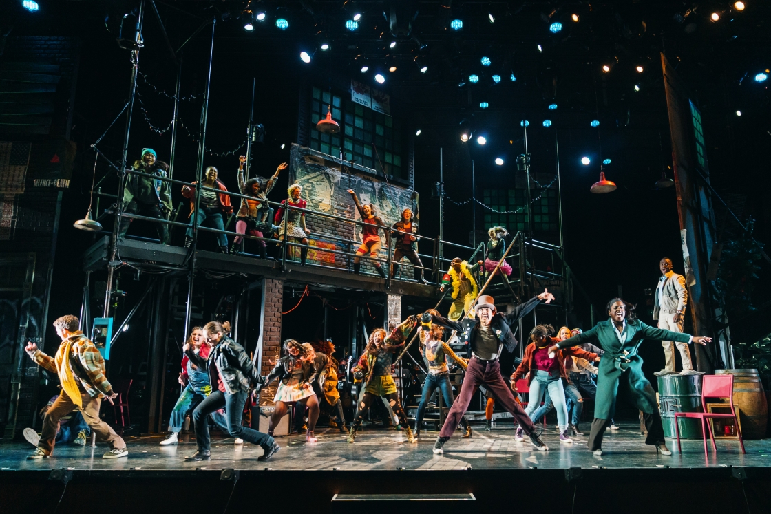 Large group of actors dancing in RENT