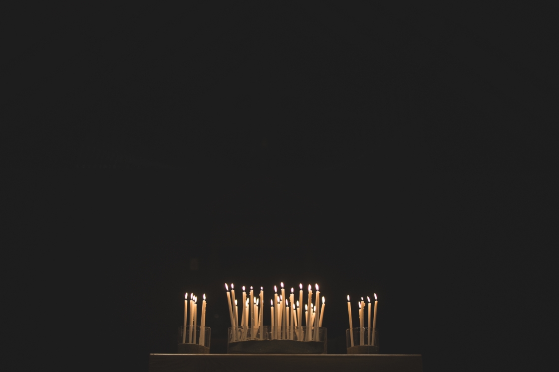 Candles lit in a dark space