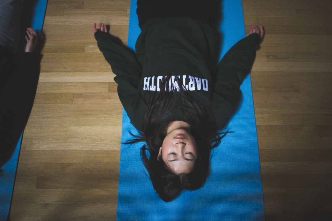 Student lying on a yoga mat
