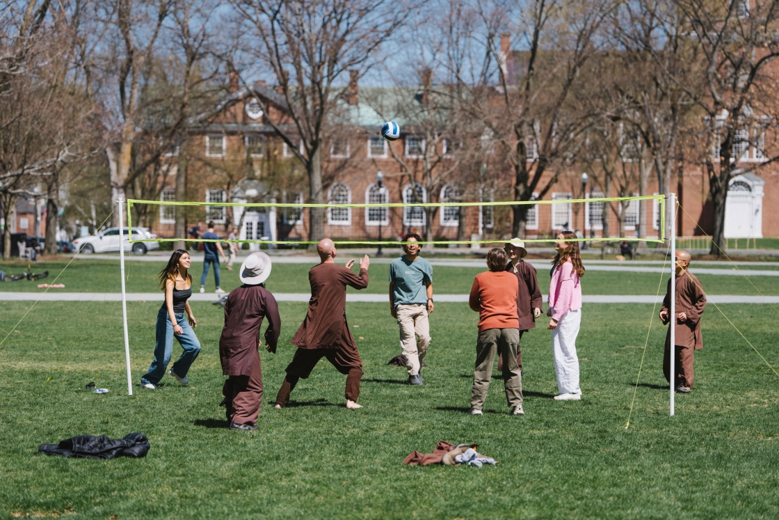 Monks play volleyball with students