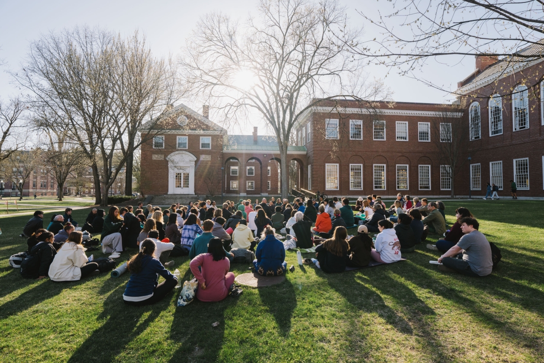 Large group sits in a cluster on Baker Lawn