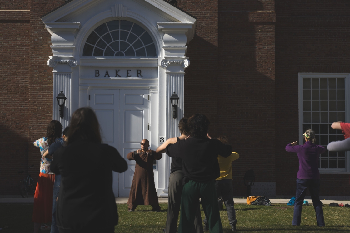 Monks and community members do qigong on Baker Lawn