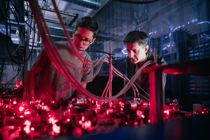 Student and professor looking at laser field