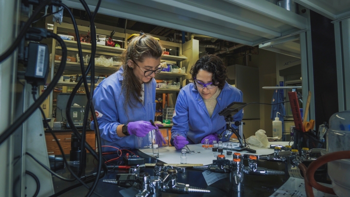 Two women in laboratory examining a cloth sample