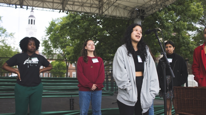 Students rehearsing reading names of graduates for Commencement.