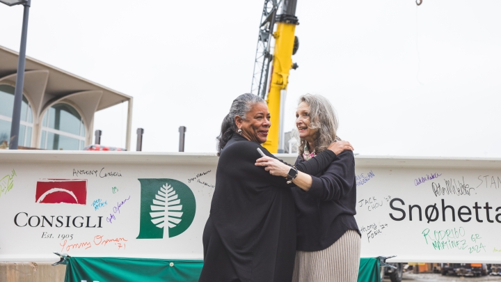 Laurel Richie '81 and Mary Lou Aleskie embrace after signing the steel beam