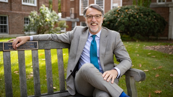 Dean of Admissions and Financial Aid Lee Coffin Sitting on a bench in fall