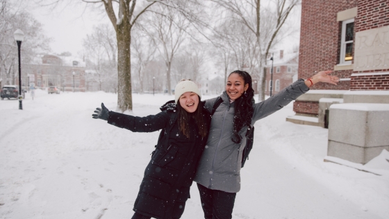 Two people posing in a snowstorm