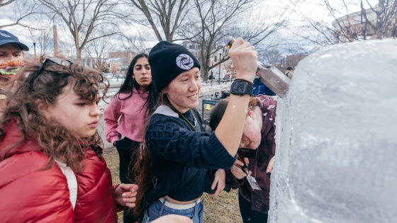 Students carving an ice sculpture