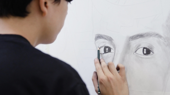 Person drawing a portrait