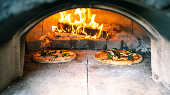 Two pizza's baking in the pizza oven