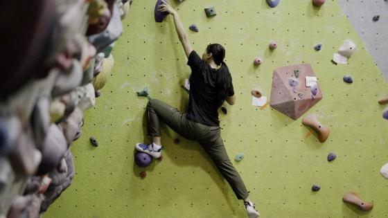 A climber bouldering indoors