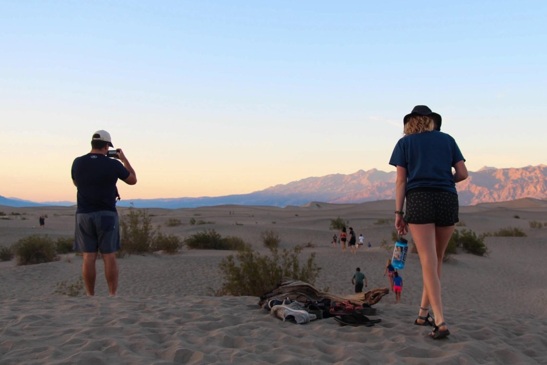 Students take photos and watch a sunset on Death Valley's Flat Sand Dunes.