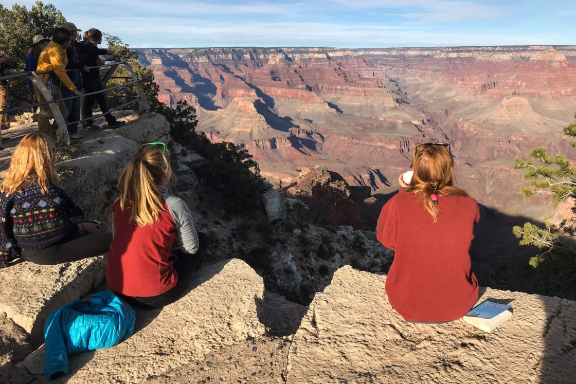 Students sitting on the south rim of the Grand Canyon.