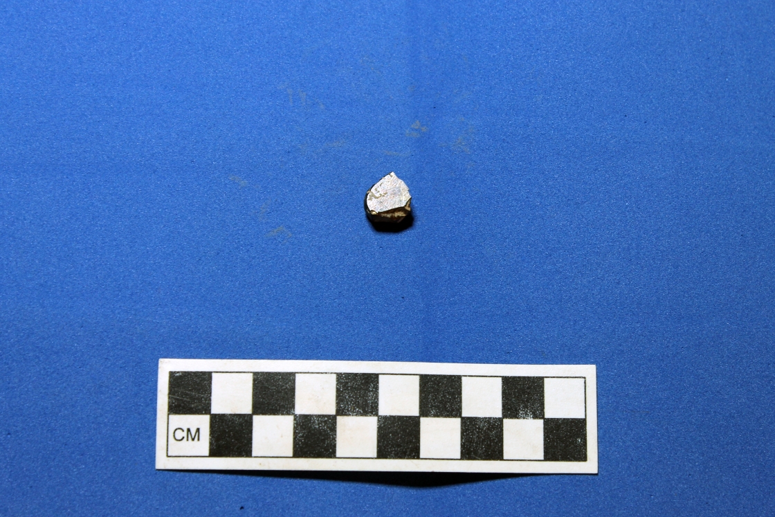Fragment of polished magnetite found alongside other artifacts.