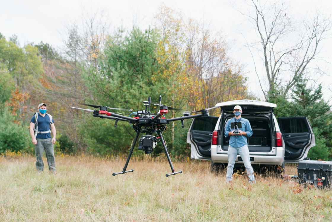 David Lutz watches Eben Broadbent use a drone