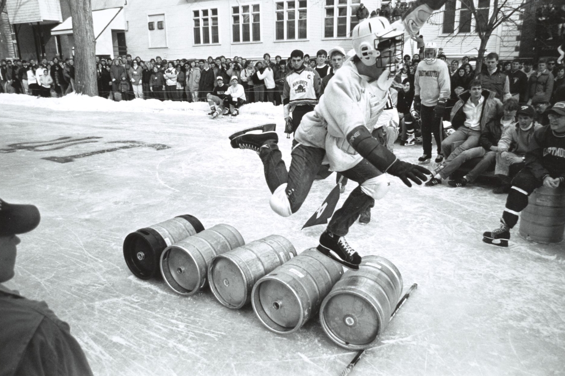 Skater leaping over 5 beer kegs