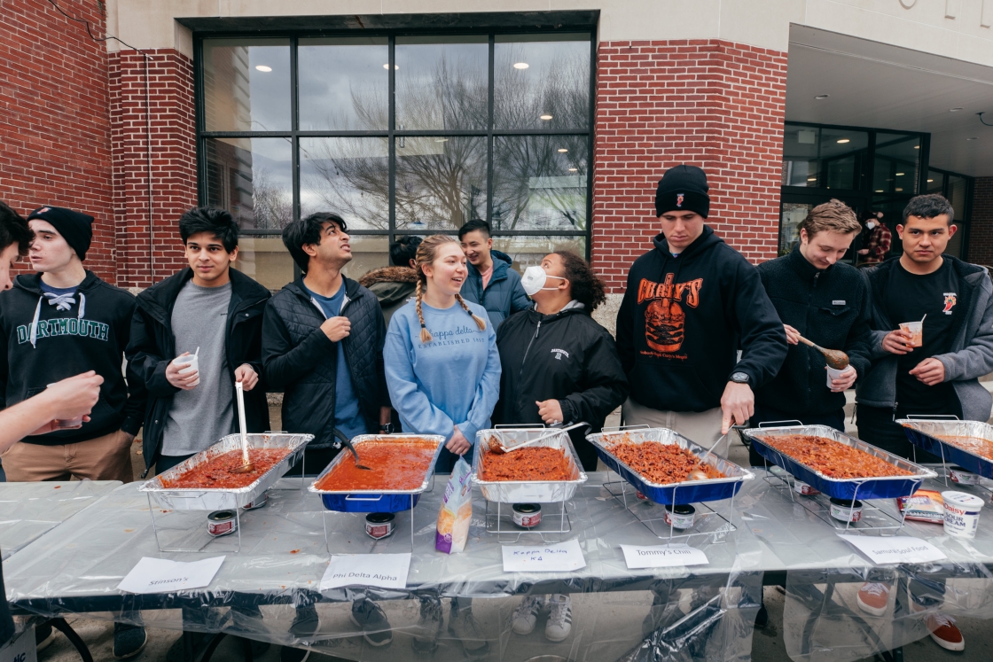 Students serving trays of chili