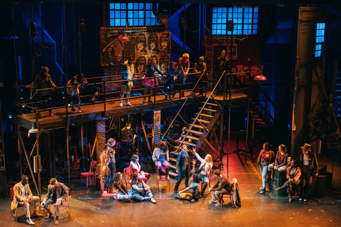 Actors on stage and in the balconies on the set of Rent