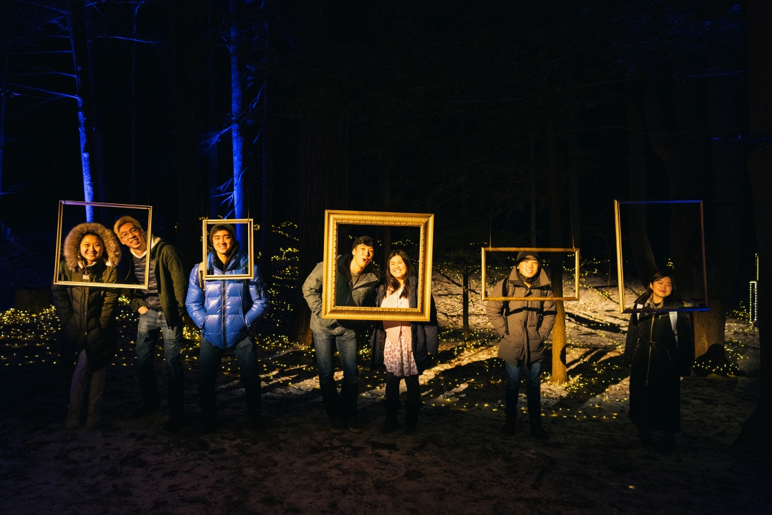 Students posing behind floating frames in the Bema