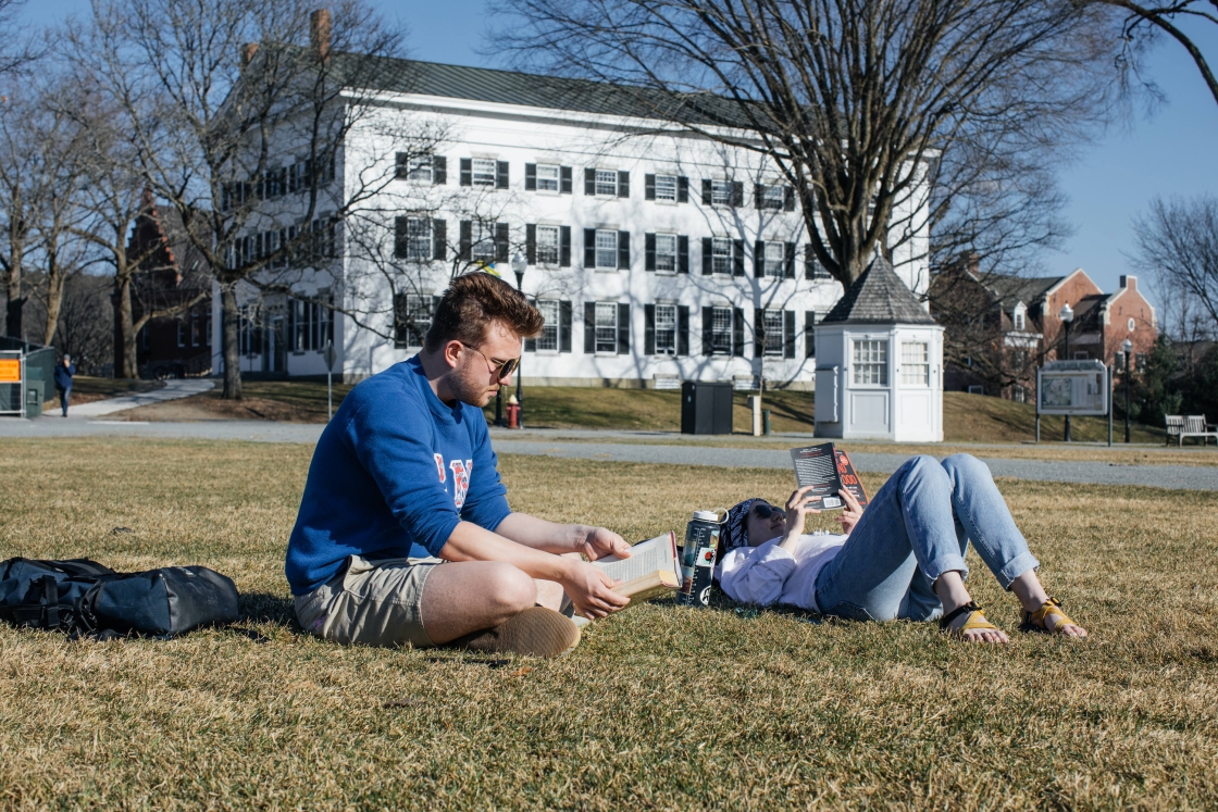 Two students studying on the Green