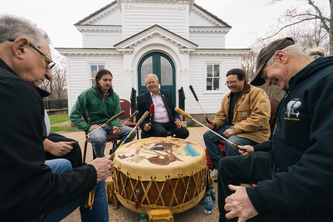 A group of people drumming outside of a church