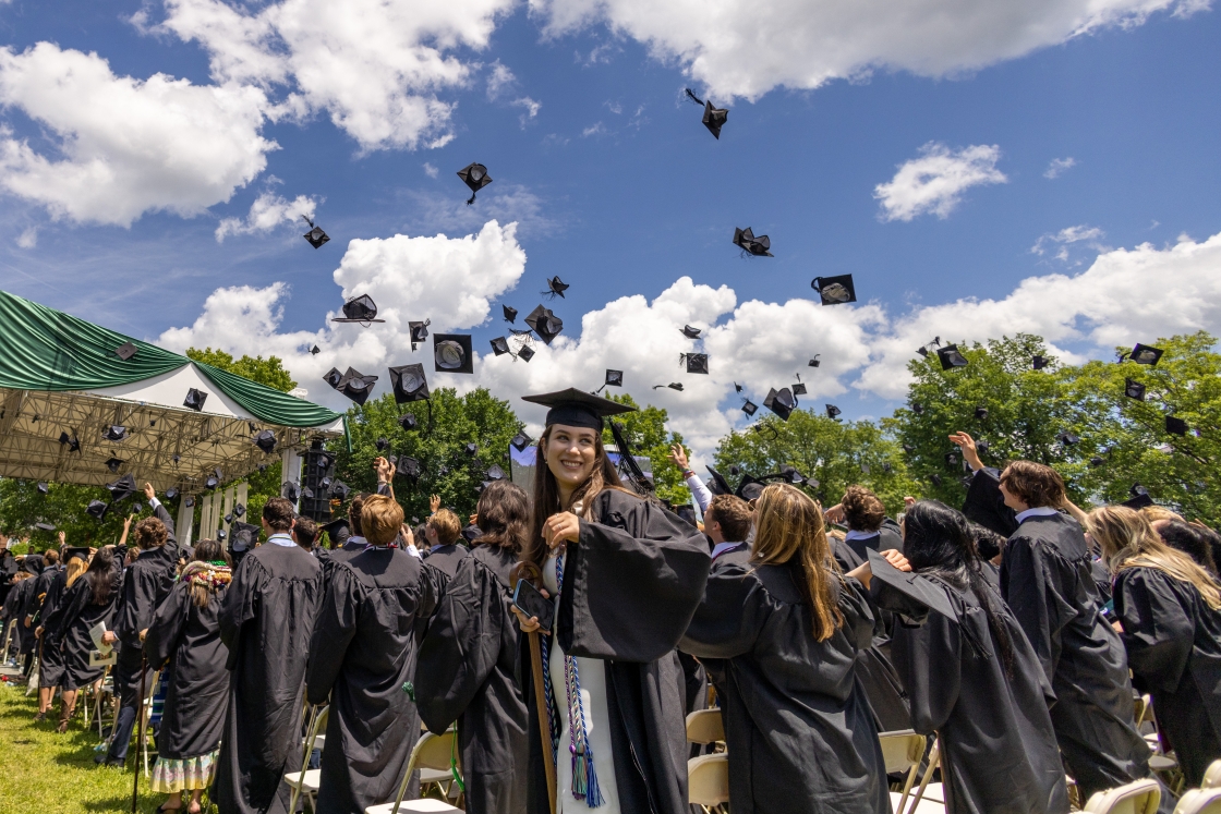 Students throw their hats in the air during Dartmouth commencement