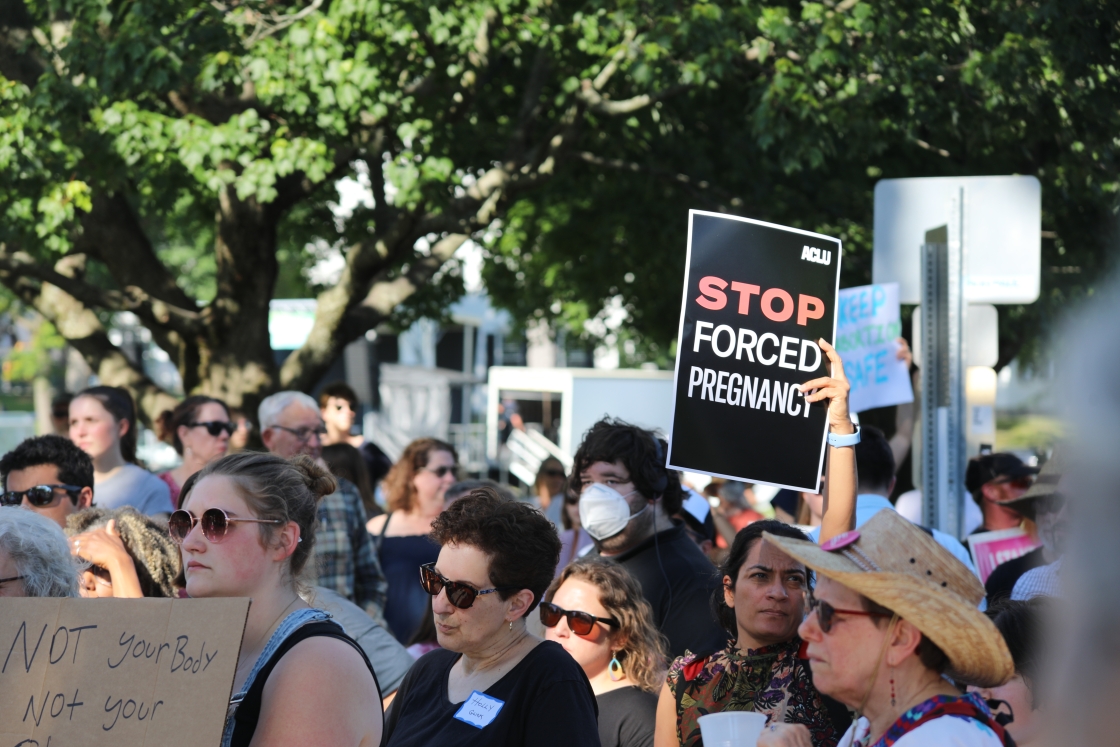 Protesters gather on the Dartmouth green a sign says Stop Forced Pregnancy