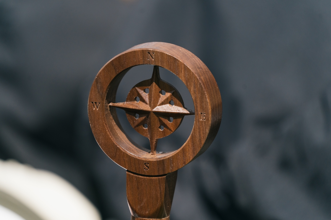 Wood carved compass on top of a cane