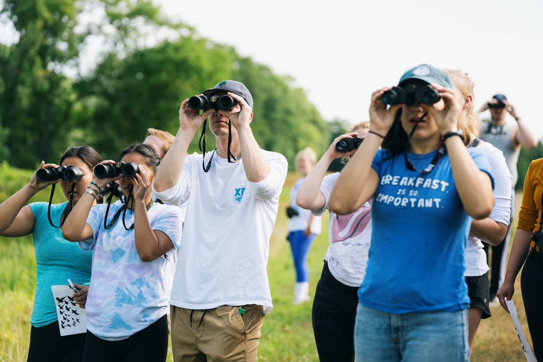 Students looking through binoculars