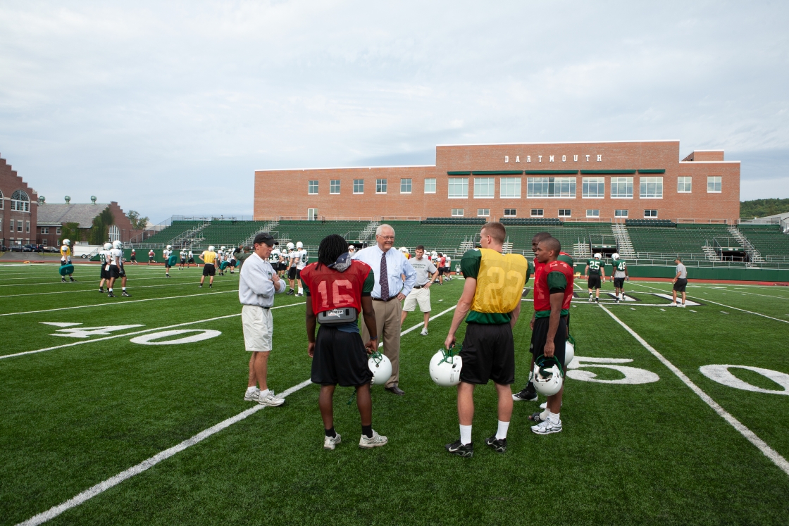 Jim Wright chats with football players on Memorial Field