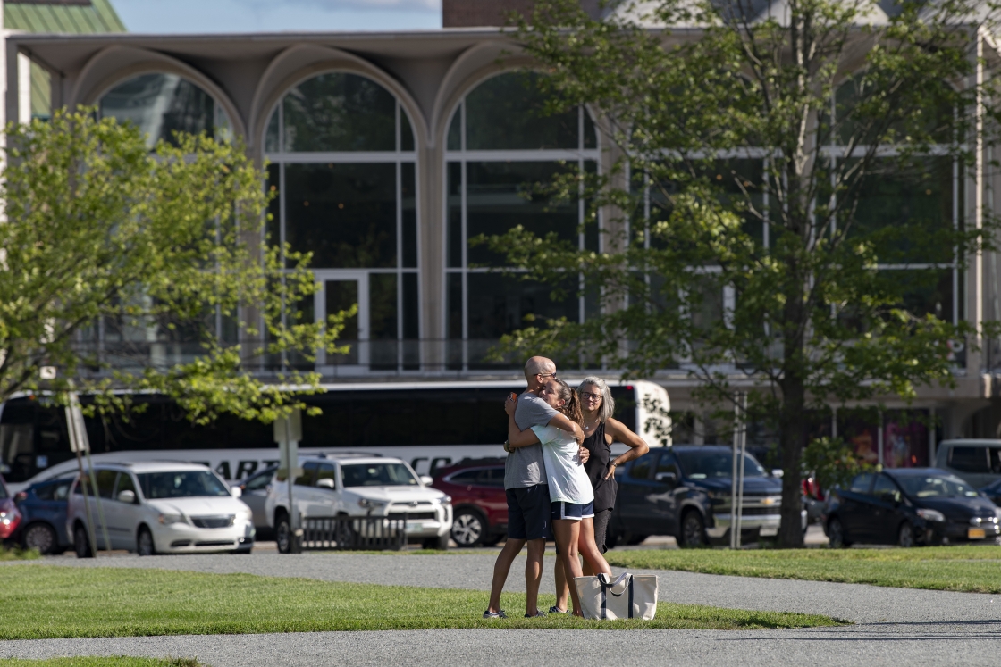 Parents hug student on the Green