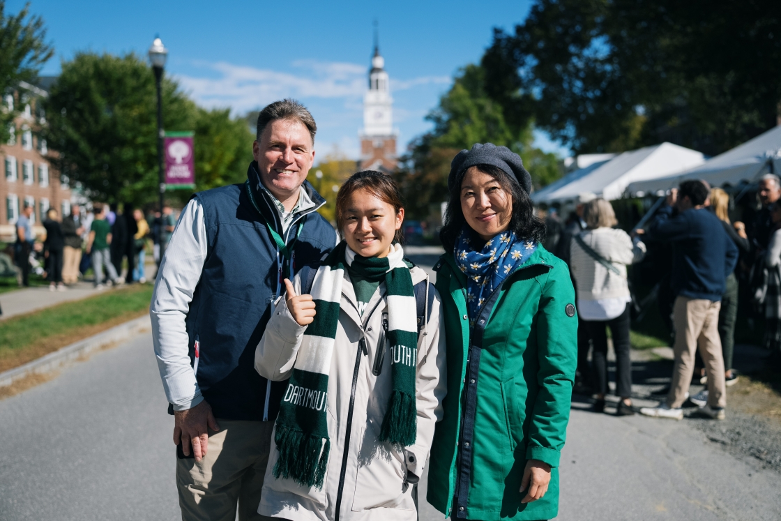 Student poses with parents at Dartmouth College
