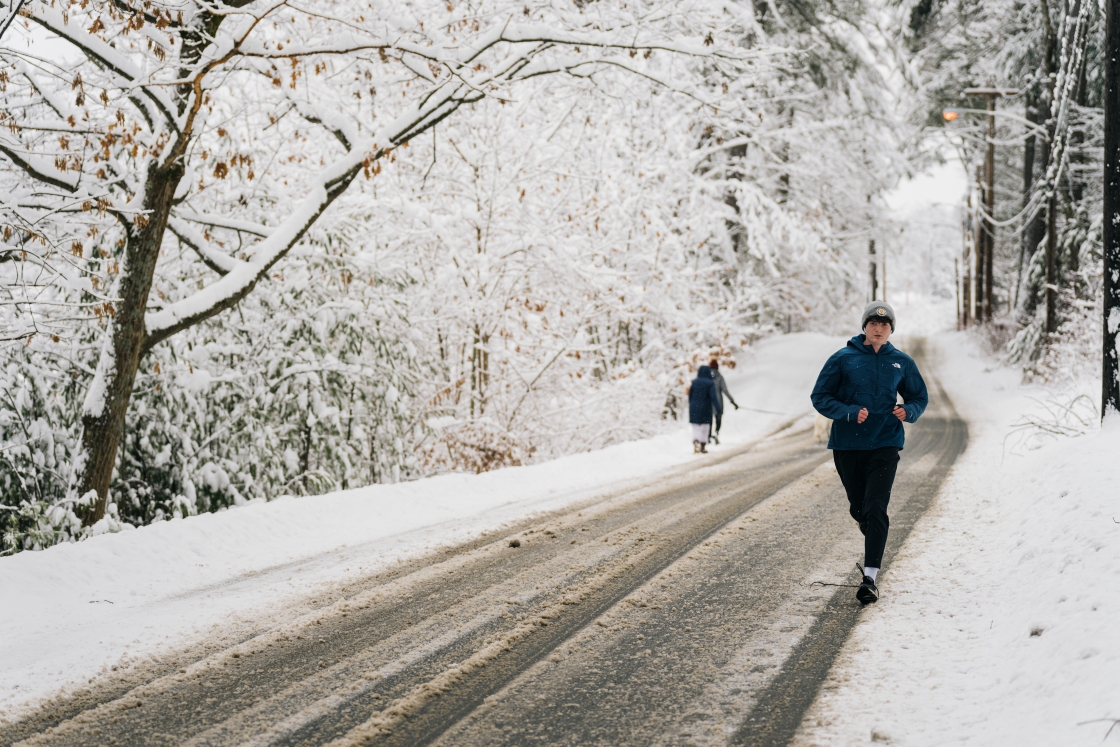A man running down a snowy road