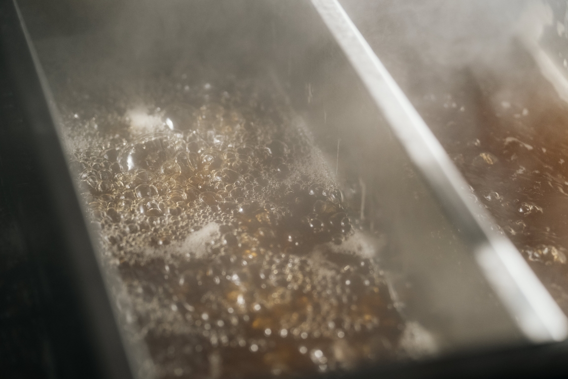 Steam rising from the sap boiling in the pan.