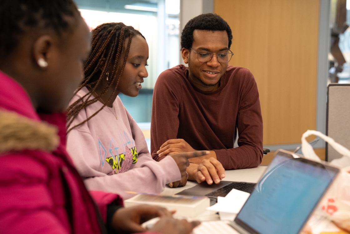 Three students study inside Baker-Berry Library.