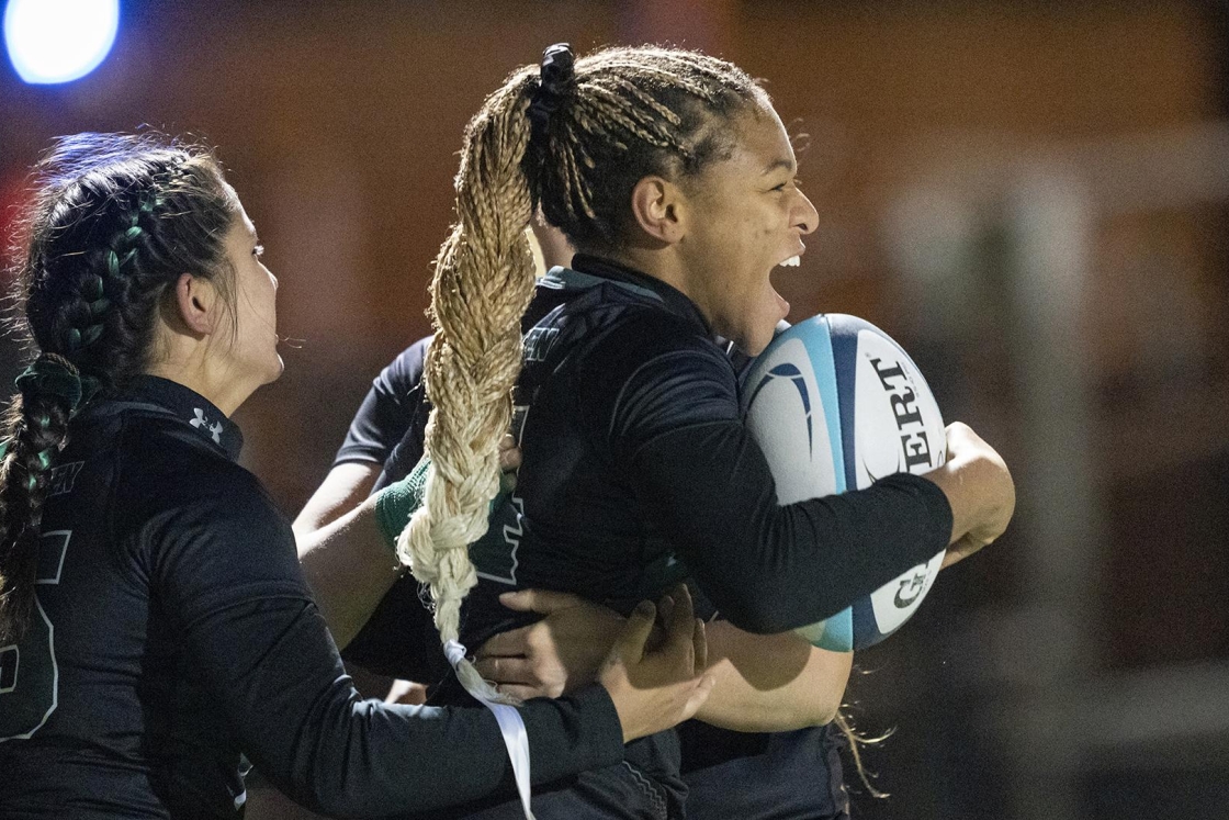 Ariana Ramsey '22 clutches a rugby ball.