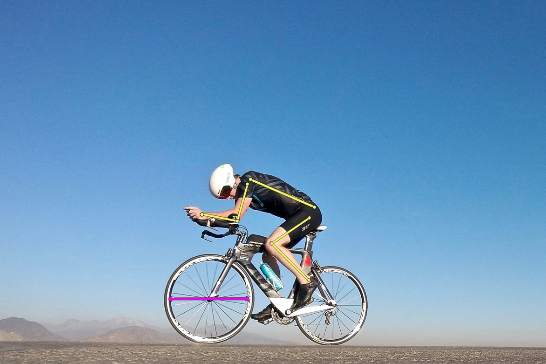 Man on racing bike with measurement lines overlain