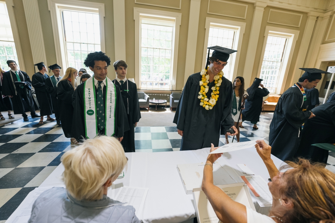 Students receive diplomas in the Baker-Berry library