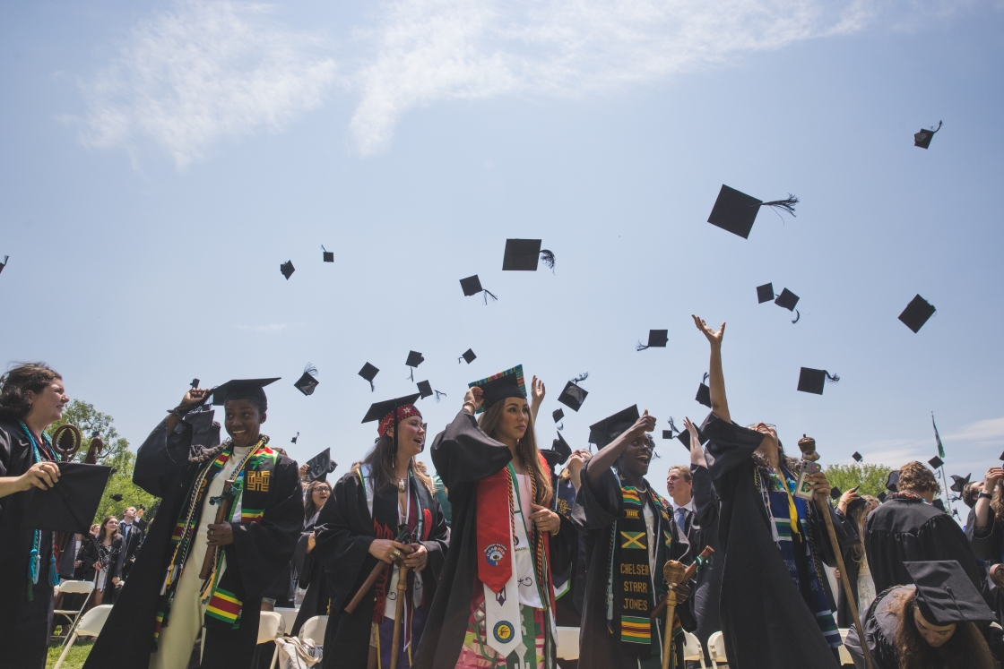 Students toss their caps in the air after Commencement