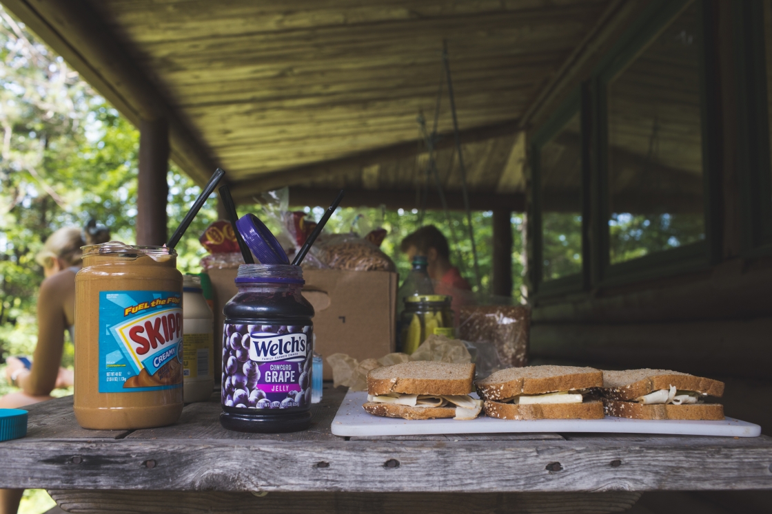 Sandwiches and peanut butter and jelly on a table