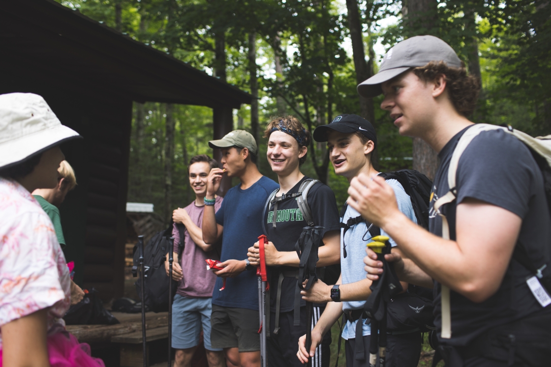 Students talking outside a cabin