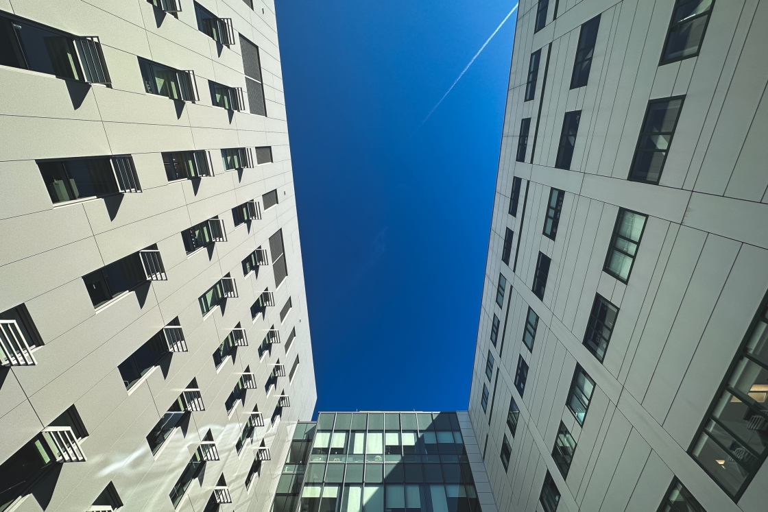 A plane flies over the Williamson Translational Research Building