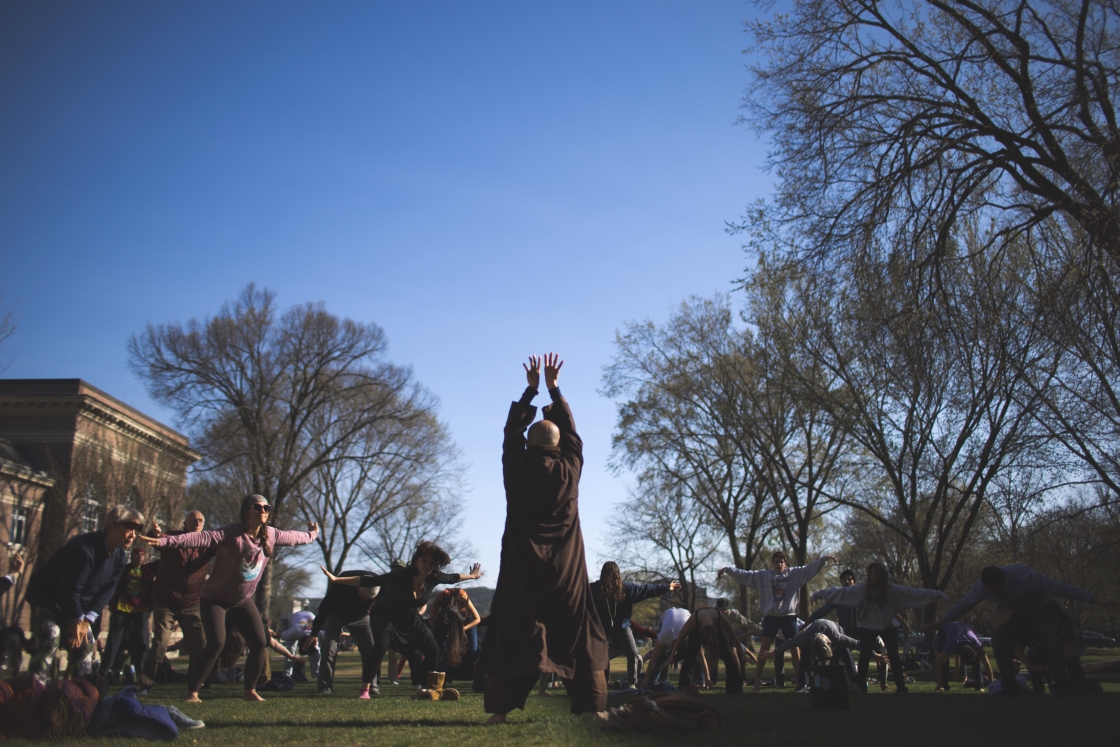 Monks lead students in qigong on the Baker Library lawn