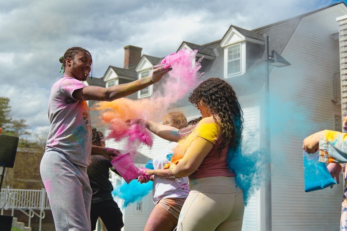 Students throw colored powder at each other during the festival