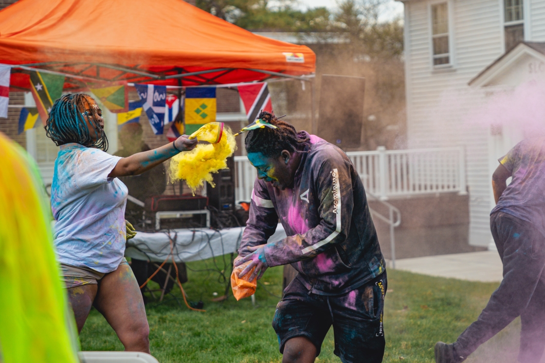 Azaire Andre and Jonathan Hayles throwing colored powder