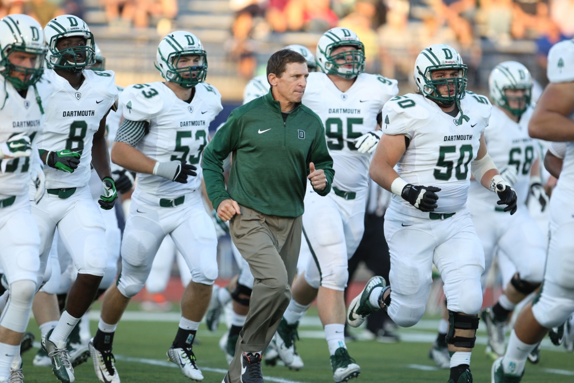 Buddy Teevens and Dartmouth Football run out to the field at UNH