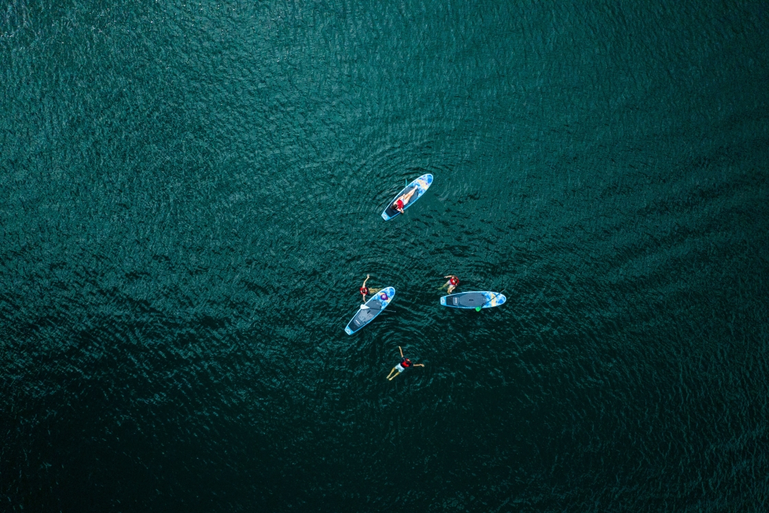 Aerial of paddle boards and swimmers in Lake Morey