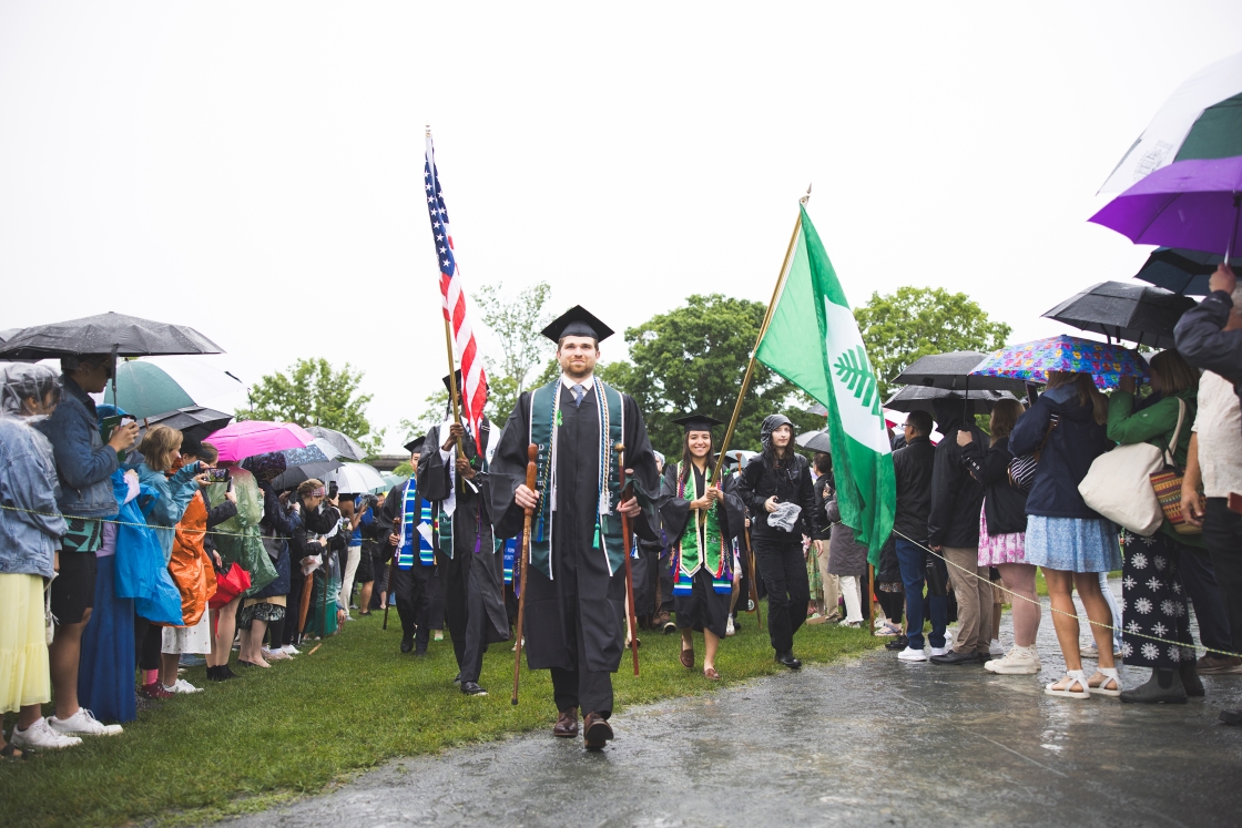 Dartmouth graduates walk during a rainy Commencement