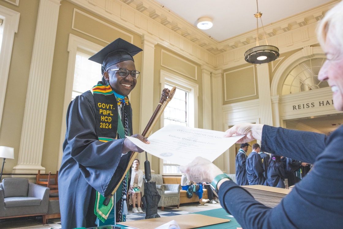 A Dartmouth graduate receives their diploma